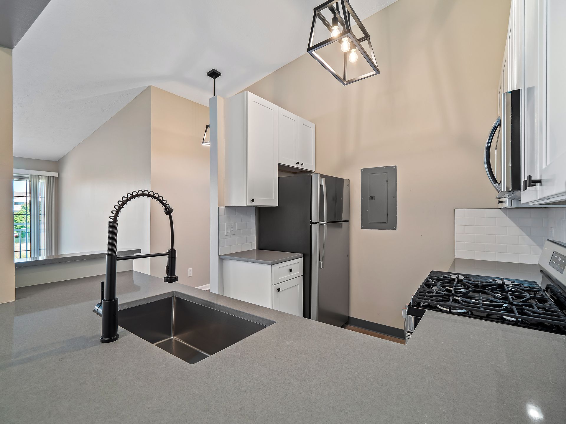 Renovated kitchen with quartz counters and modern fixtures